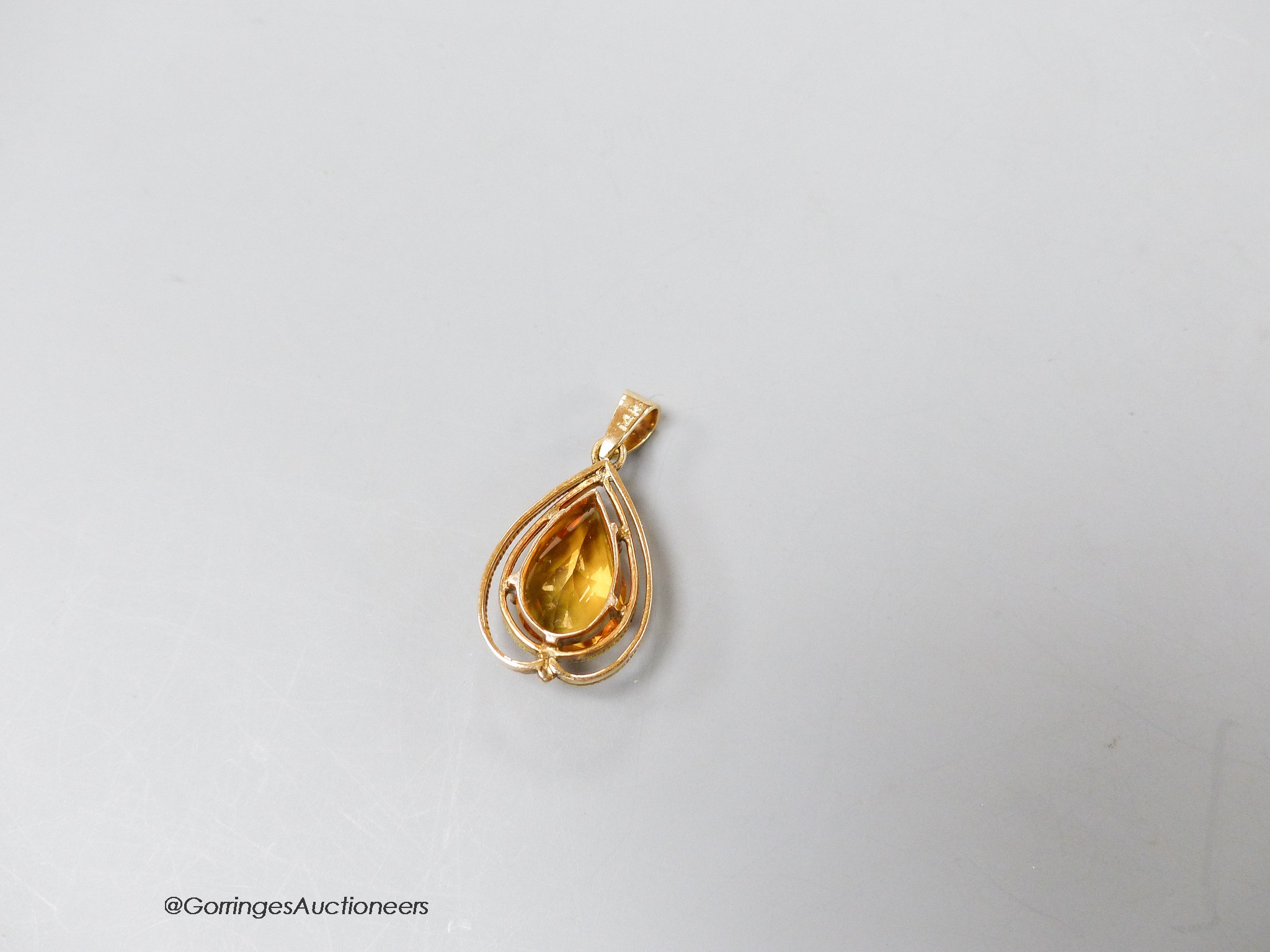 A 14k yellow metal and pear shaped citrine set drop pendant, 29m, gross 3.7 grams.